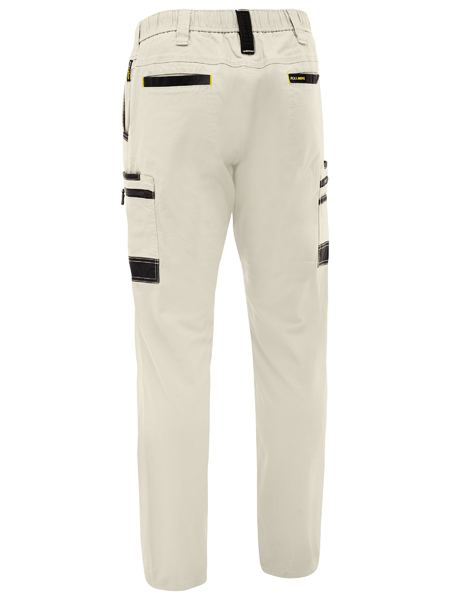 Beige work pants with black zippers and accents on a white background