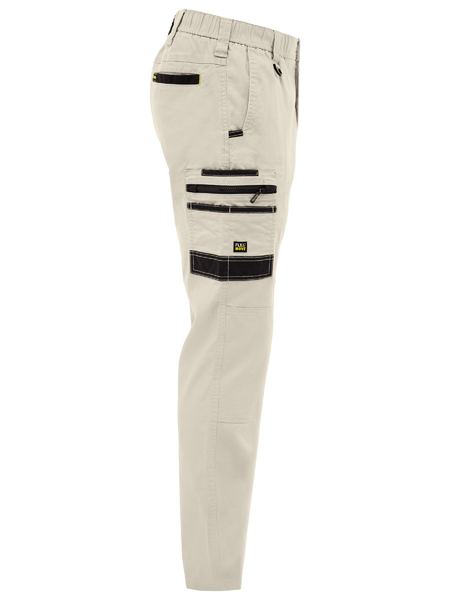 Beige pants with black zippers on a white background